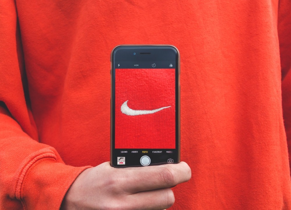 iphone with nike emblem on red background