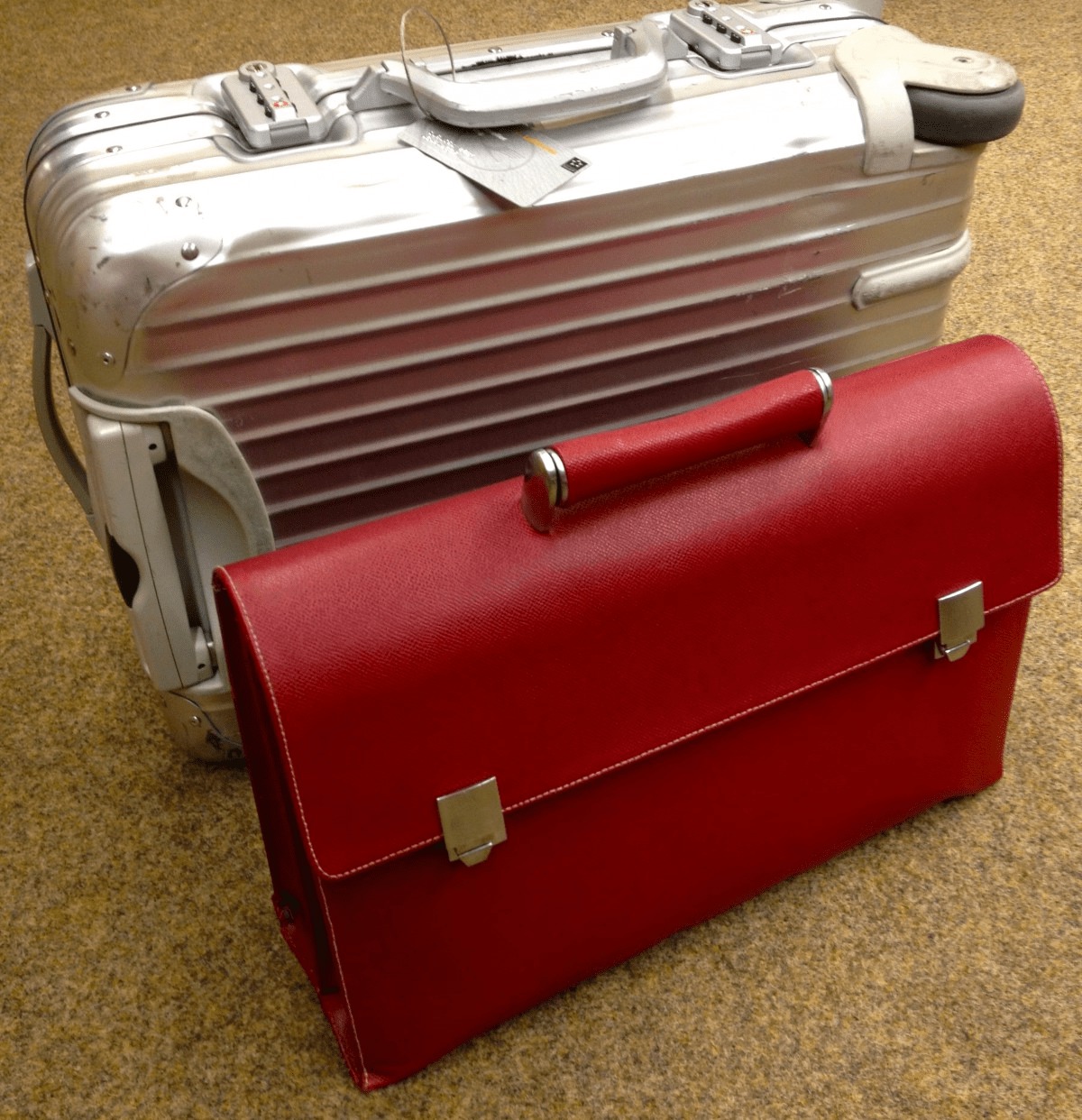 red briefcase silver hard case suitcase business on the road traveler
