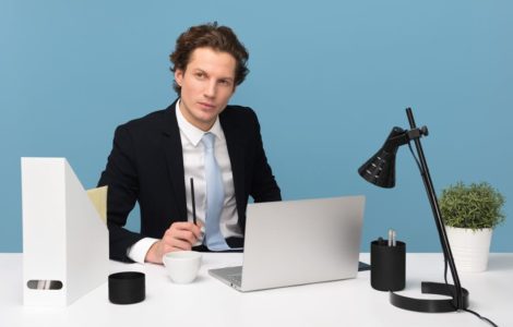 business man sitting at his desk with open laptop