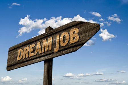dream job sign on wooden arrow direction board