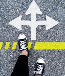 feet-in-sneakers-at-directional-arrows