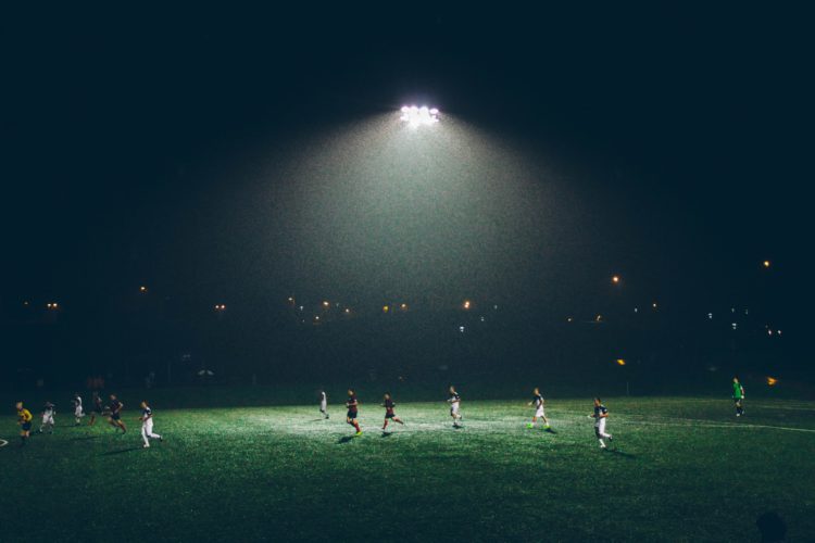 football players on a field at night