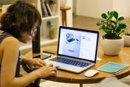 how to start a charity woman at open laptop