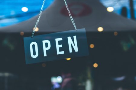 open sign on glass business door