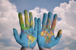 the world globe painted on the palms of two hands creative thinking examples
