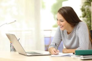 how to improve your work productivity woman at open laptop