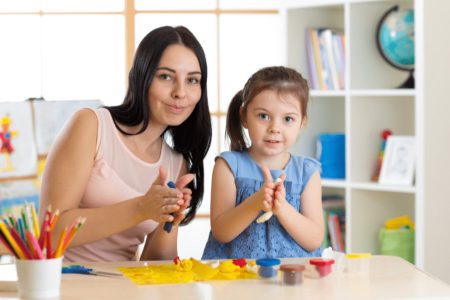 mother and daughter working with play dough