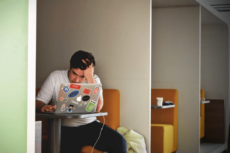 stressed man at open laptop techniques to reduce stress