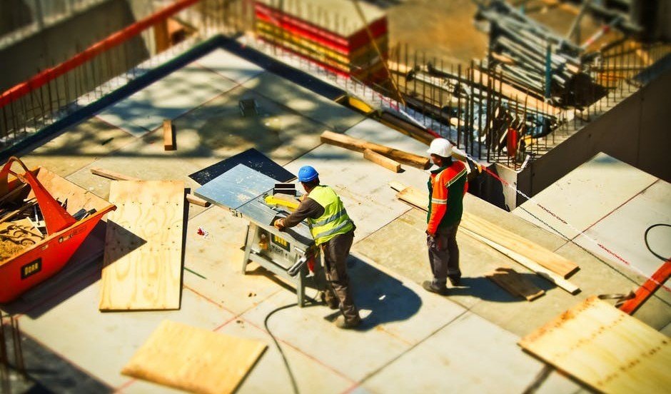 workmen cutting wood at a building site