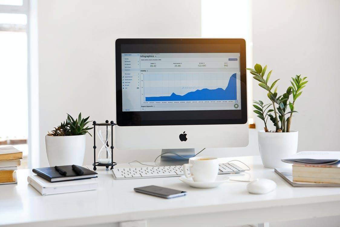 Silver Imac Displaying Line Graph Placed on Desk increase your online sales fast