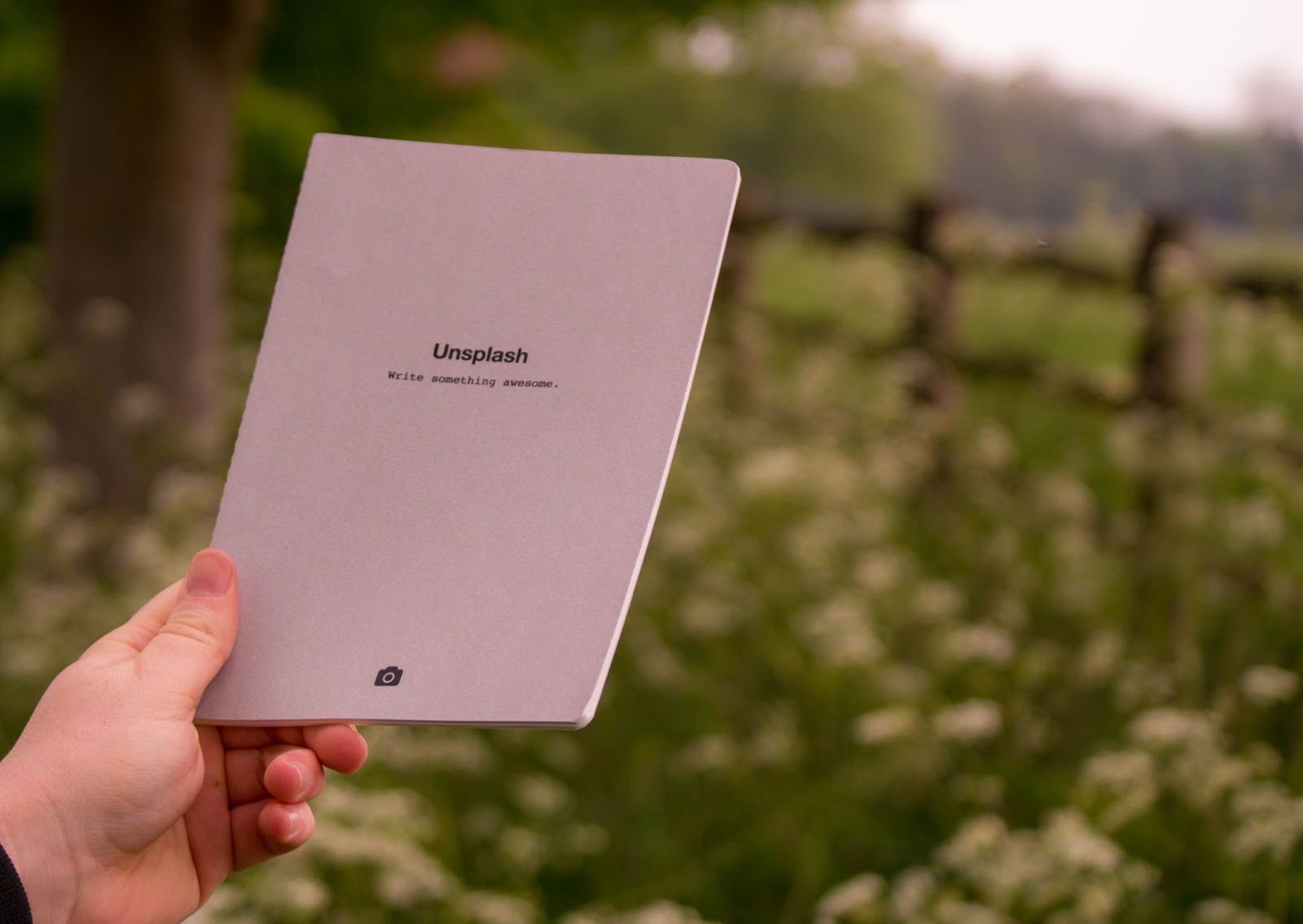 using promotional products like this hand holding a business folder with company logo