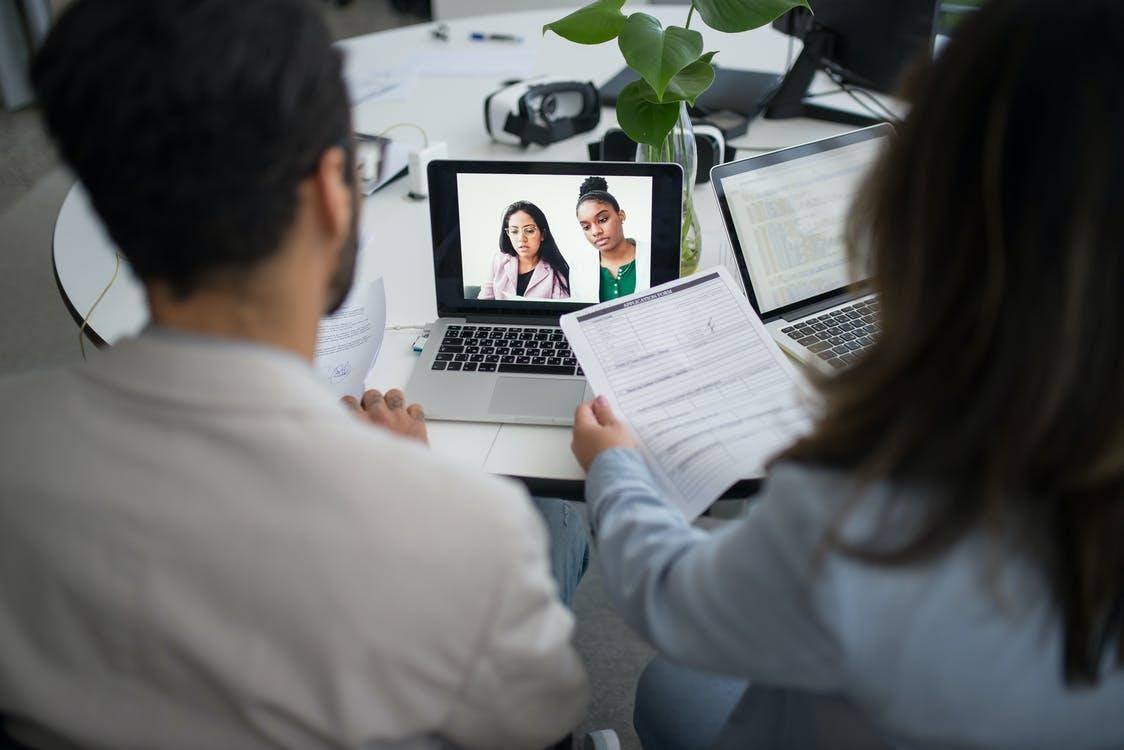 Woman in White Long Sleeve Shirt Using Macbook Pro online reputation