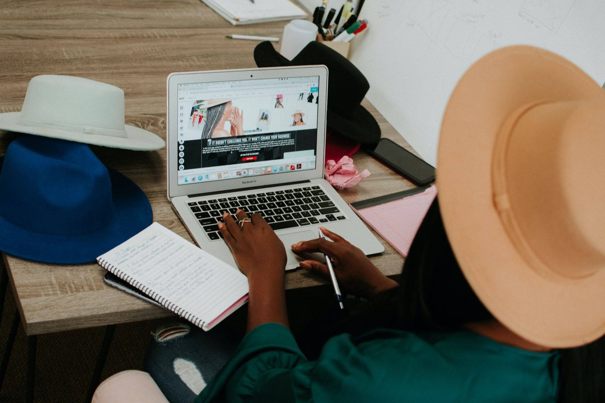 woman wearing brown hat with open laptop work-life balance