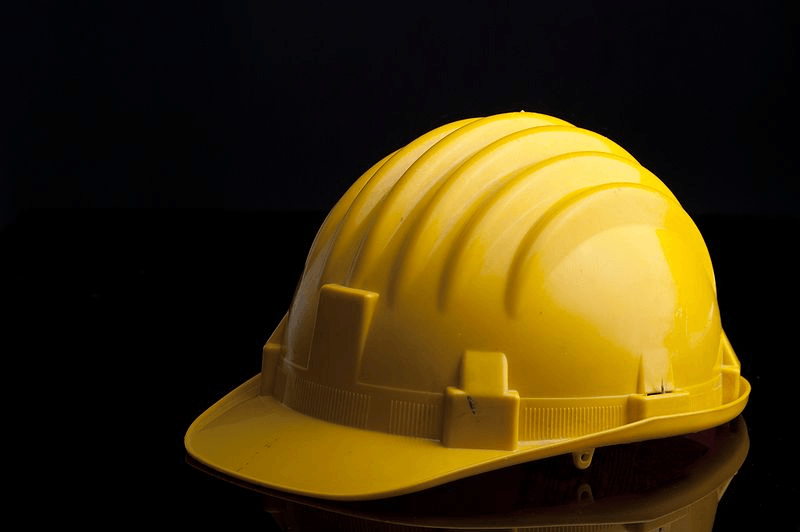 yellow safety hat a part of health and safety regulations