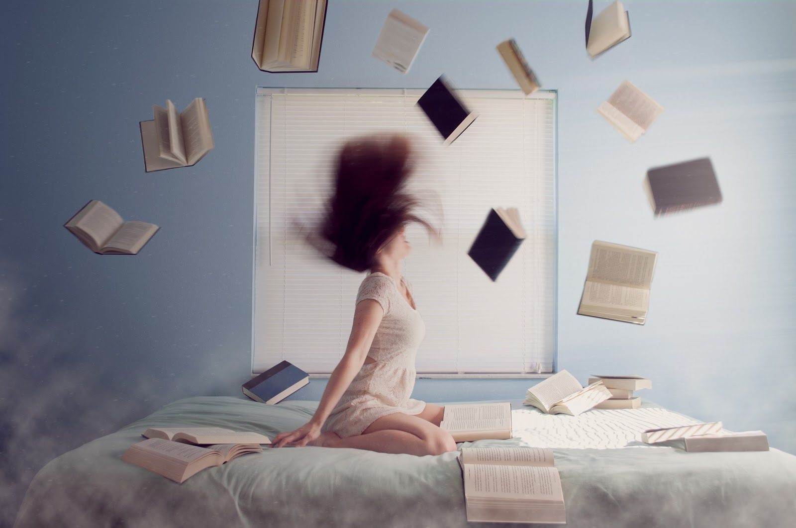 woman shaking head on bed books flying around her when things go wrong 