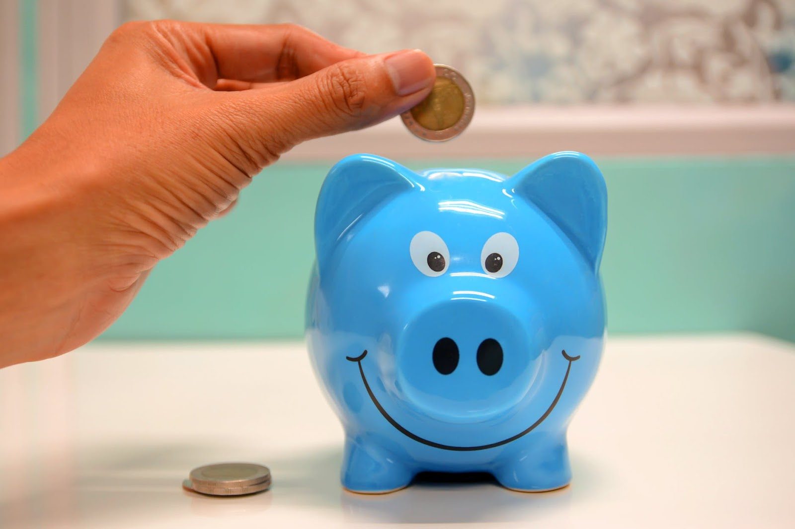 person-putting-coin-in-a-piggy-bank-free tools for business equals savings