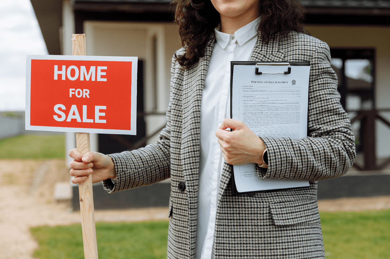 close-up-of-a-woman-holding-a-home-for-sale-sign real estate business