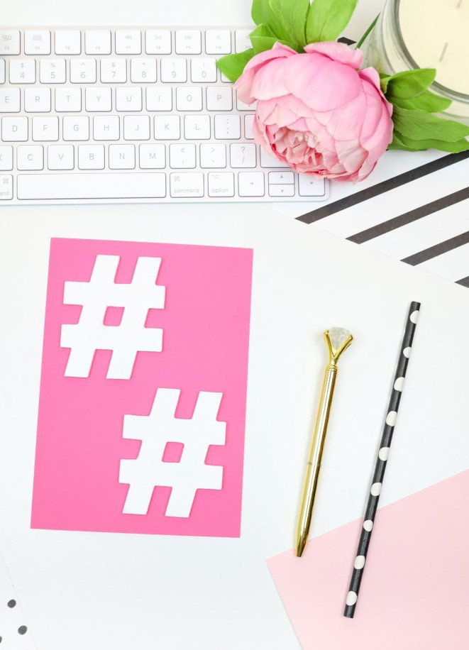 white hashtag icon on pink paper background with white keyboard