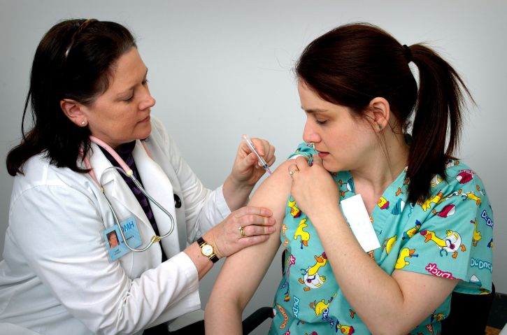 female giving injection in scrubs is one of the health care business tips