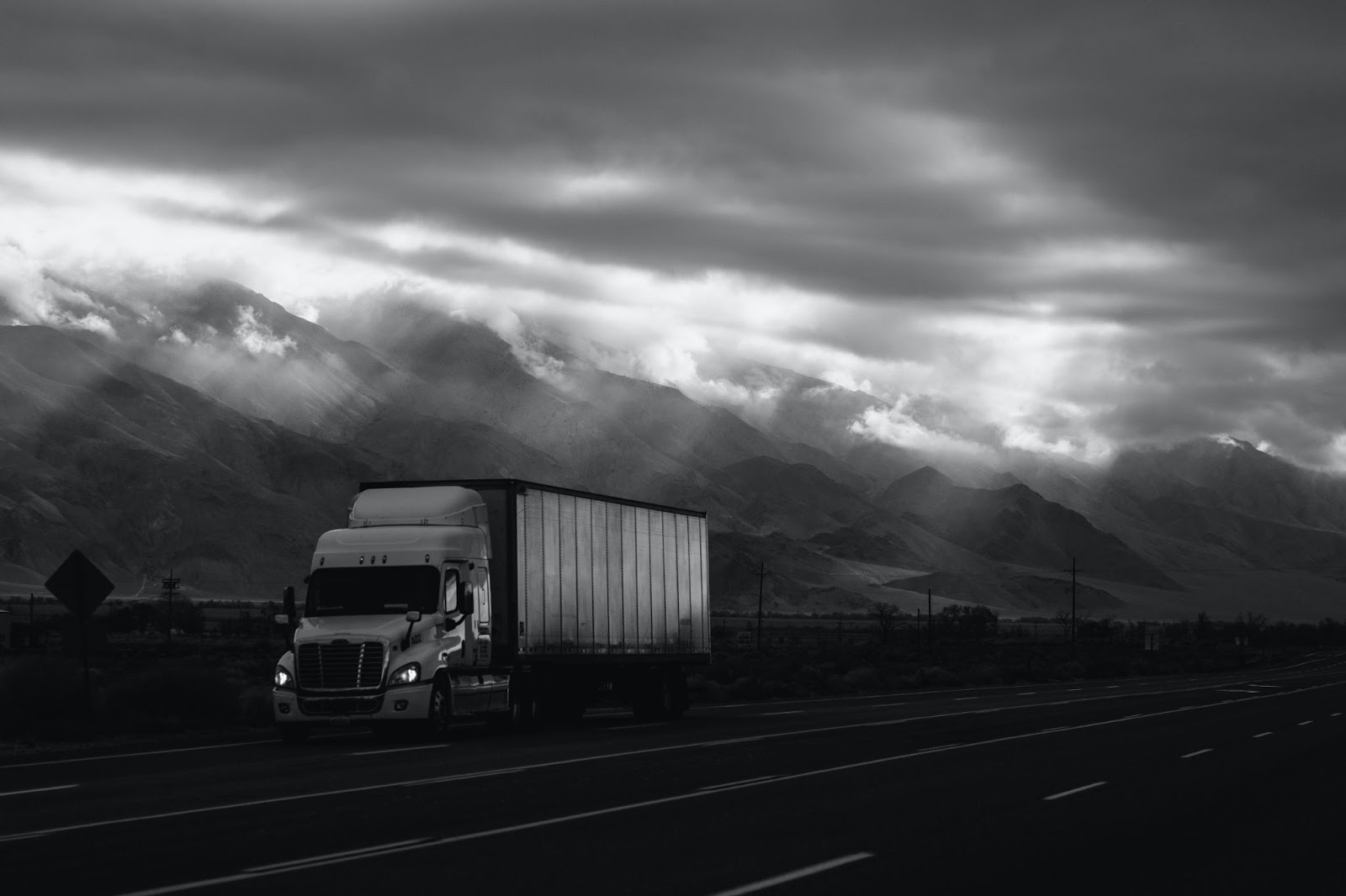 truck driving in overcast weather running a trucking business