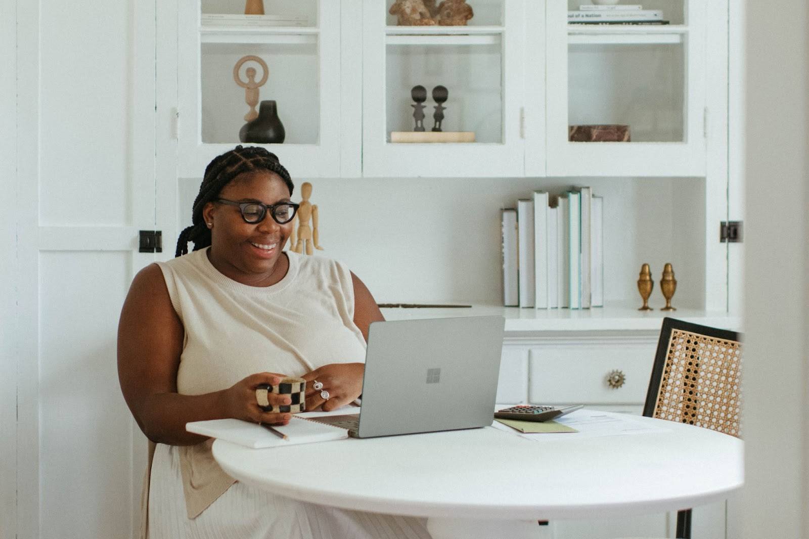 woman sitting at desk with open laptop tech business tips